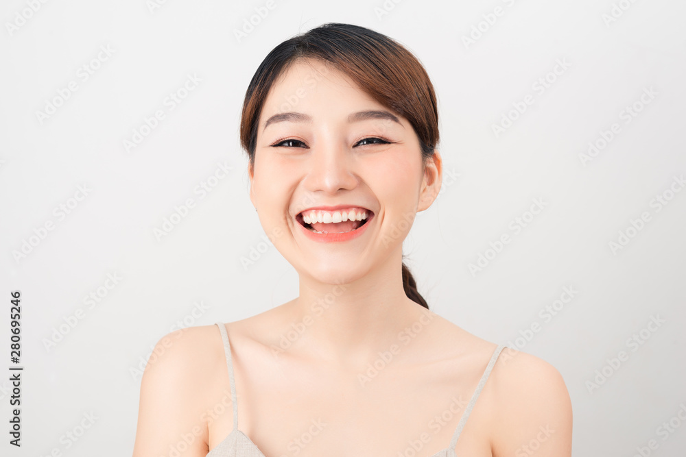 Beautiful smiling woman with clean skin, natural make-up, and white teeth on white background Beautiful smiling woman with clean skin, natural make-up, and white teeth on white background