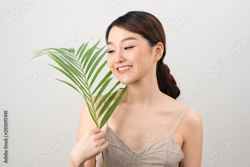 Beautiful woman of Asian appearance palm leaf nature skin care