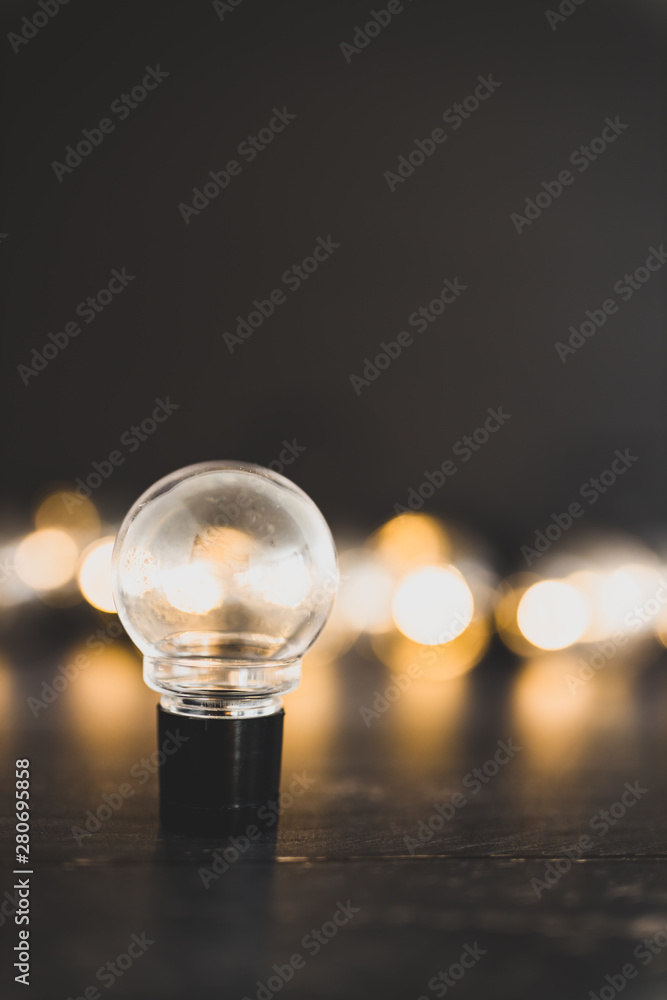 light bulb alone in front of group of other globes, concept of unique ideas