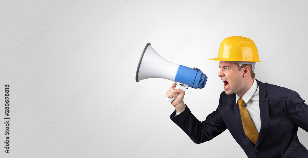 Young architect constructor yelling with megaphone and copyspace Young architect constructor yelling with megaphone and copyspace
