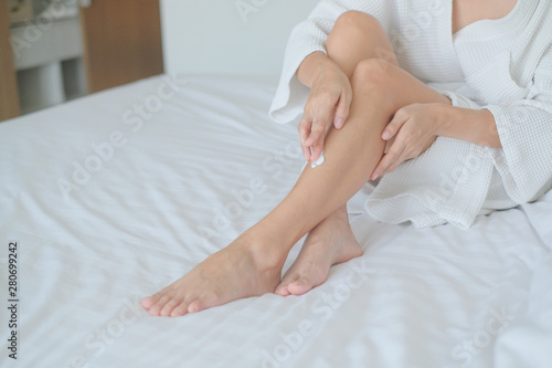 Woman applying legs cream,lotion , Hygiene skin body care concept. © BoszyArtis