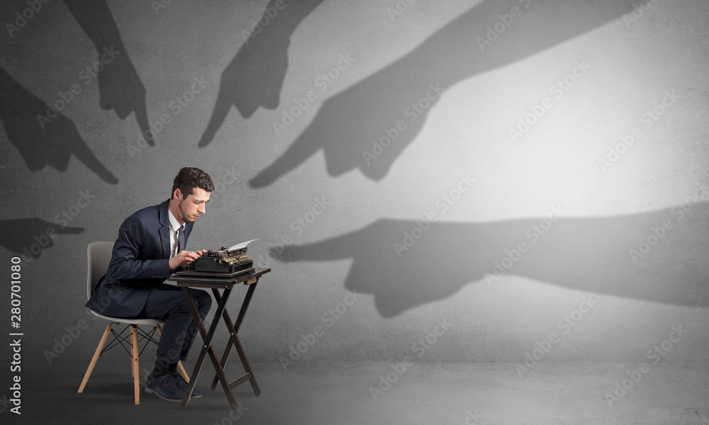 Shadow hand pointing at a small afraid worker Shadow hand pointing at a small afraid worker