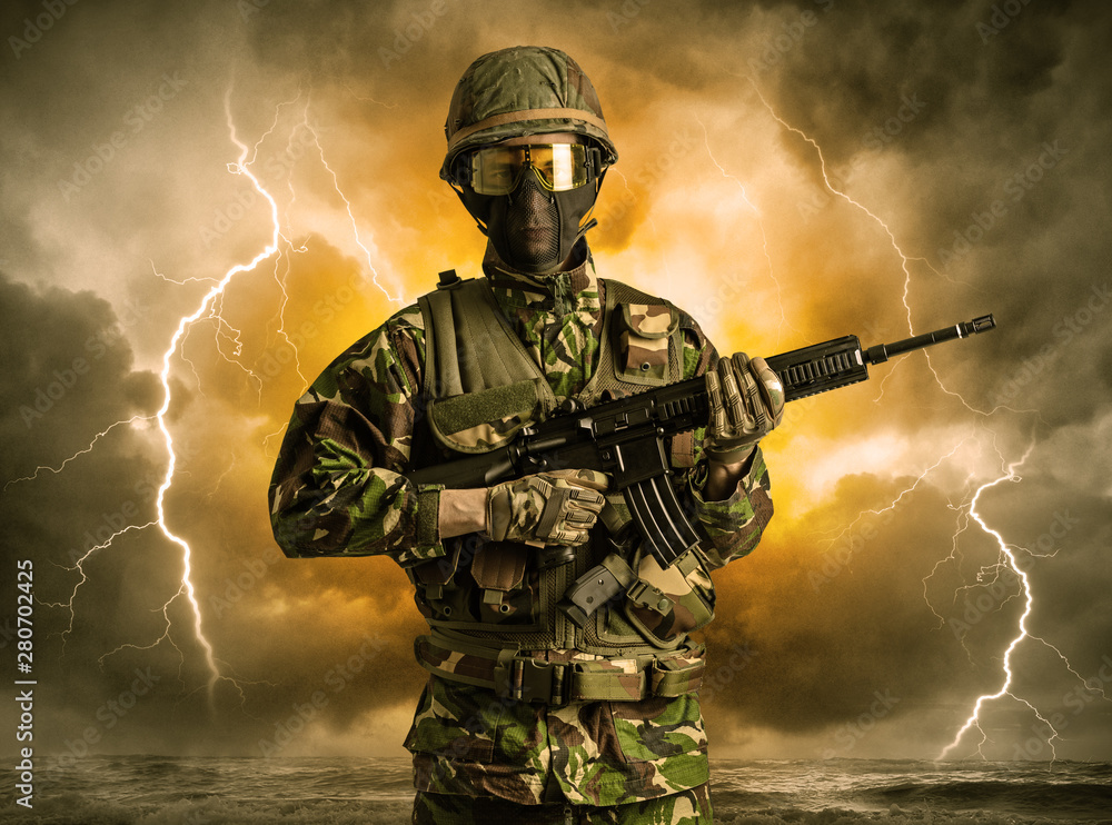 Armed soldier standing in rainy obscure weather Armed soldier standing in rainy obscure weather