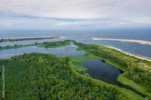 Aerial view of the Vistula river mouth to the Baltic sea. Poland. Photo made by drone from above. Bird eye view.