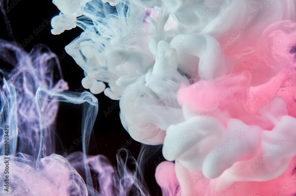 Pink and white acrylic ink in water on black background. Abstract background. Pink and white acrylic ink in water on black background. Abstract background.