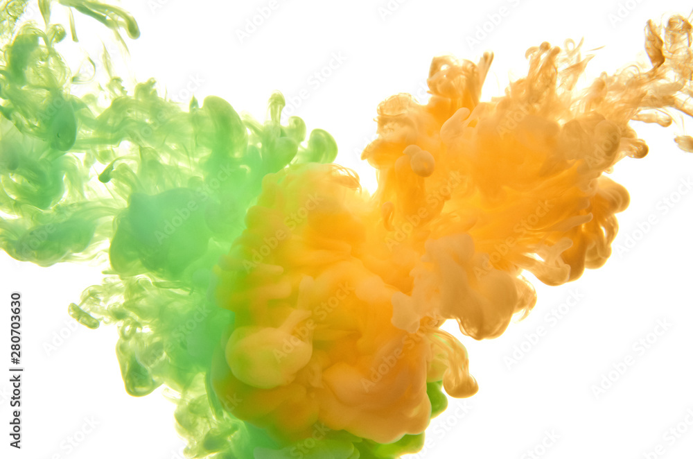 Green and orange acrylic ink in water on white background. Abstract background. Green and orange acrylic ink in water on white background. Abstract background.