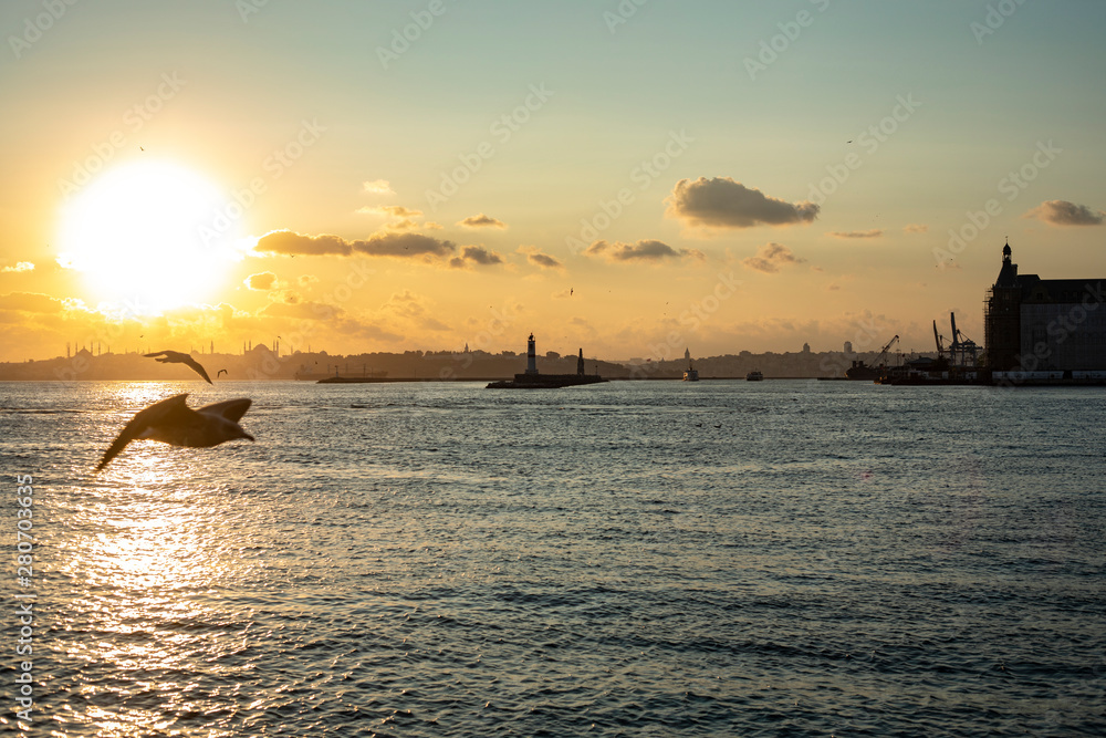 Cityscape of Istanbul with silhouettes of ancient mosques and minarets at sunset. Panoramic view, The Maiden's Tower, Galata Tower, Hagia Sophia, The Blue Mosque and Topkapı Palace in Istanbul. 