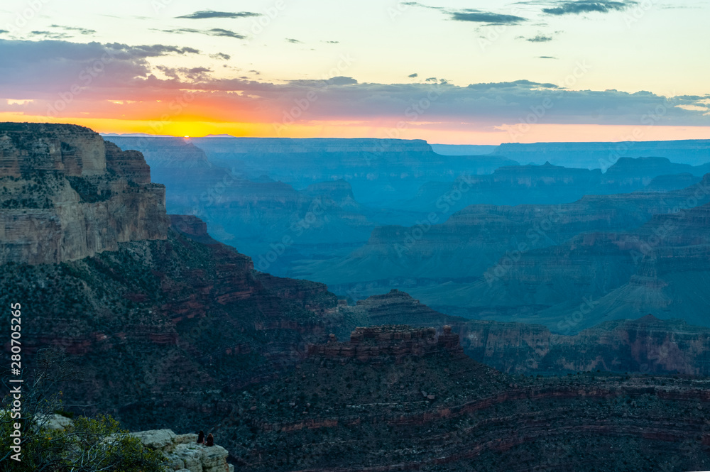 The setting sun sinking below the horizon of the Grand Canyon, near Yavapai point on the southern canyon rim.