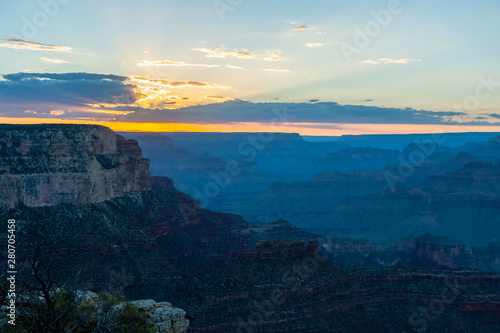 The setting sun sinking below the horizon of the Grand Canyon, near Yavapai point on the southern canyon rim.