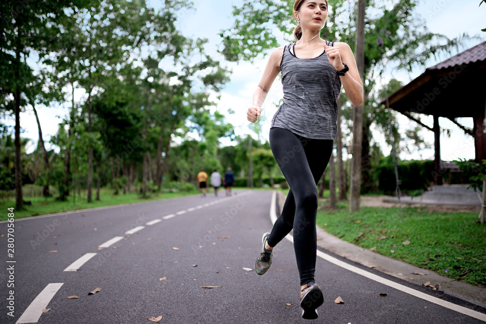young asian woman runner athlete running at garden young asian woman runner athlete running at garden