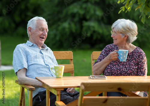 Old couple drinking tea in park