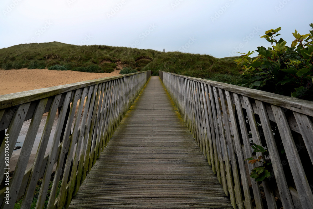 Wooden Footbridge Over a River Estuary to the Beach