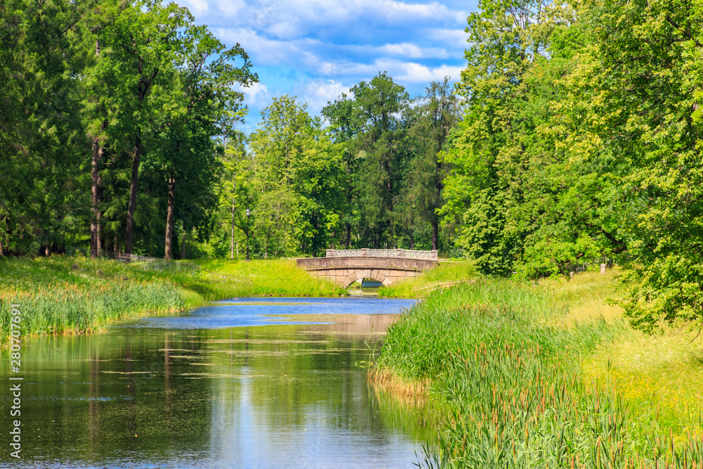 Stone arch bridge across a small river in Catherine park in Pushkin (Tsarskoye Selo), Russia Stone arch bridge across a small river in Catherine park in Pushkin (Tsarskoye Selo), Russia