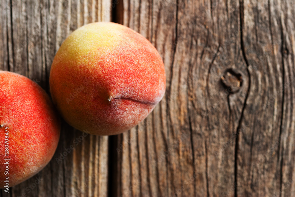 two peach fruits on old weathered wooden table background two peach fruits on old weathered wooden table background
