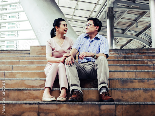 senior couple talking and happy on walking street.