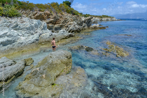 Young woman in Plage du Lotu (Loto beach), Desert des Agriates. Corsica island, France photo