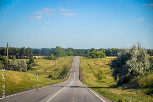 Russian asphalt roads. Highway. Road trip. The car goes on the road. Background asphalt road.
