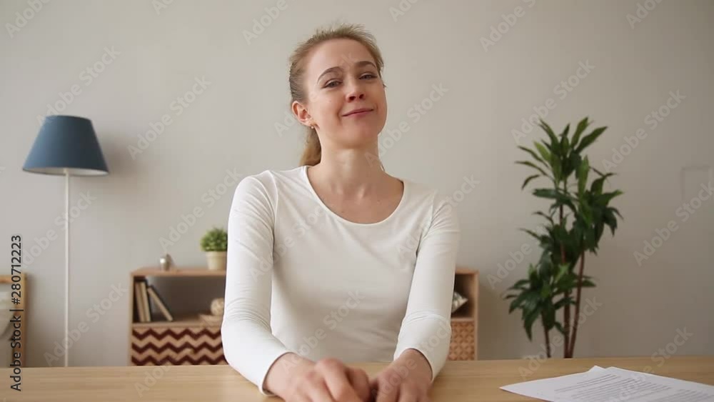Happy excited woman sitting at desk chatting looking at webcam Happy excited woman sitting at desk chatting looking at webcam