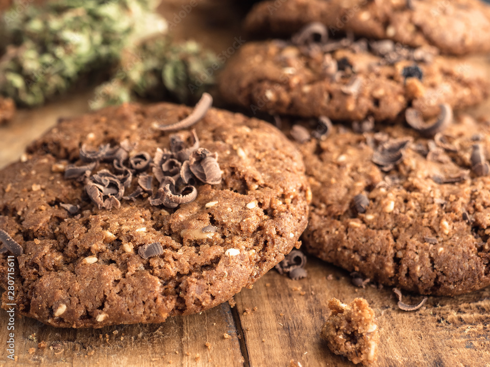 textured chocolate hemp oatmeal cookies on a wooden board textured chocolate hemp oatmeal cookies on a wooden board