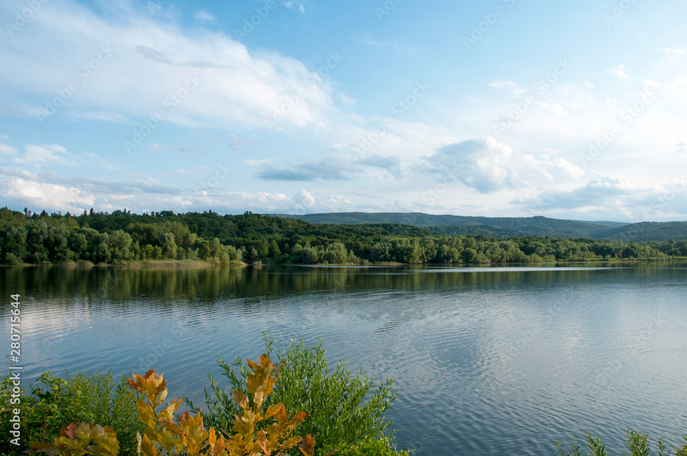 beautiful summer lake against the background of high mountains and blue sky beautiful summer lake against the background of high mountains and blue sky