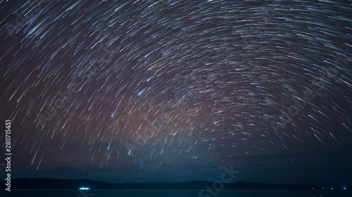 Time-Lapse startrails on a dark sky , nightscape near seascape , Zoom out. photo