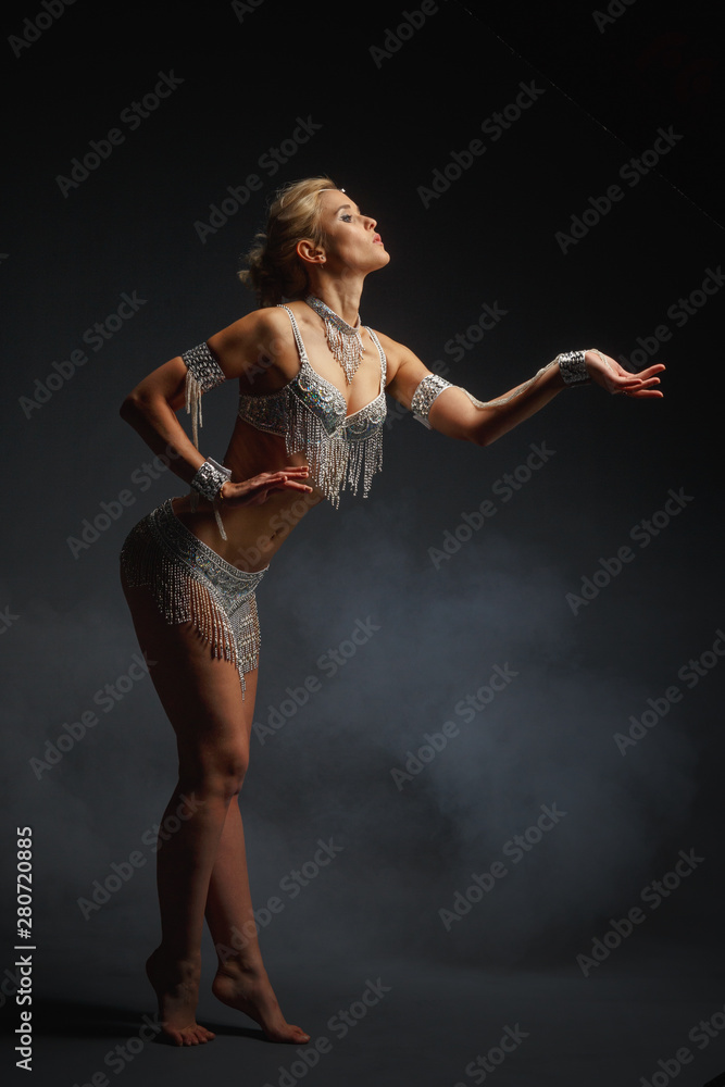 Fototapeta premium Slender girl blonde in a beautiful costume dancing Oriental dance.