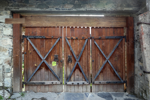 wooden gate with forged elements