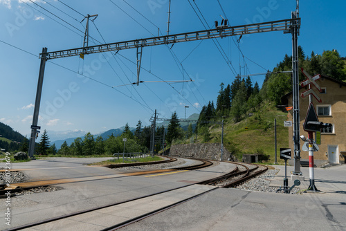 railroad track and crossing at the train station in Langwies in Switzerland