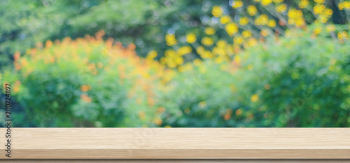 Obraz na plátně Wooden table for food, product display over blur green garden background, Empty