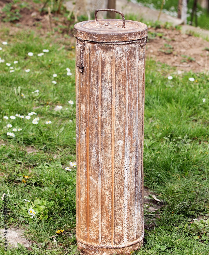 An old metal cassette the form of a roller in the garden.Used in the Second World War by the German army.