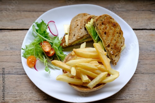 close up avocado sandwich with cheese and french fries