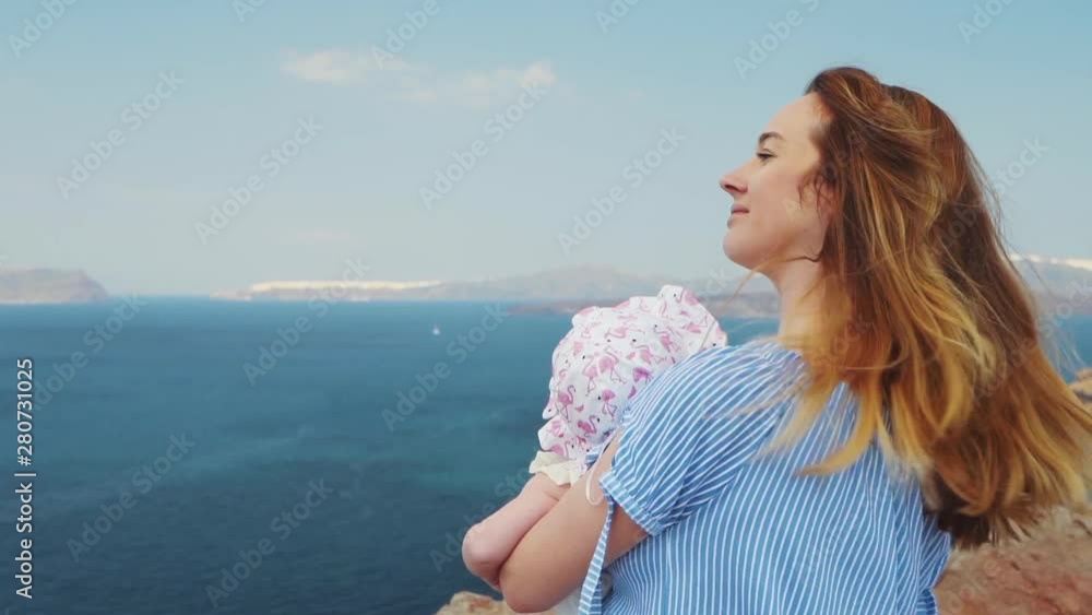 Beautiful young mother kiss daughter at the sea sunset and beach background. Happy family vacation. Caucasian happy female with baby outside at ocean sunset. Motherhood love care. Beautiful young mother kiss daughter at the sea sunset and beach background. Happy family vacation. Caucasian happy female with baby outside at ocean sunset. Motherhood love care.