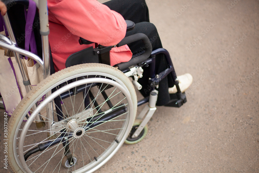 Elderly man in a wheelchair. Disabled for a walk. Problems with musculoskeletal system. Disease of the spine. Help for older people. Elderly man in a wheelchair. Disabled for a walk. Problems with musculoskeletal system. Disease of the spine. Help for older people.
