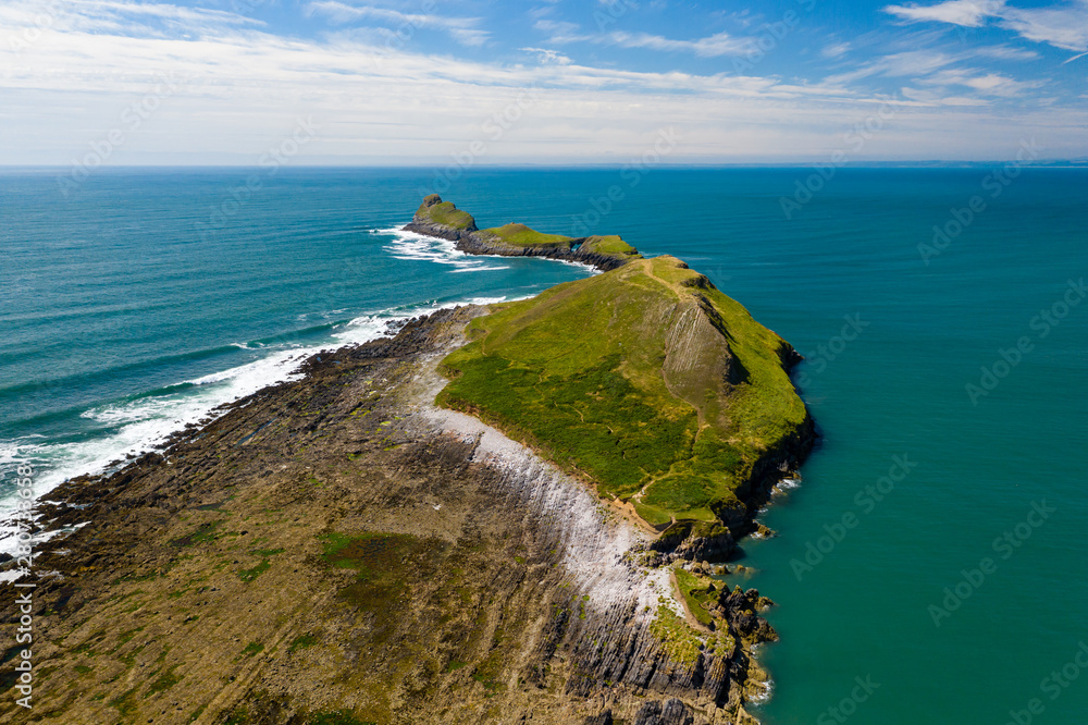 Aerial view of cliffs and waves on the Worm's Head area of the Gower peninsula
