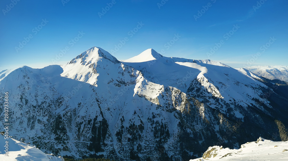 Winter panorama of Pirin mountains covered with snow in Bansko, Bulgaria.