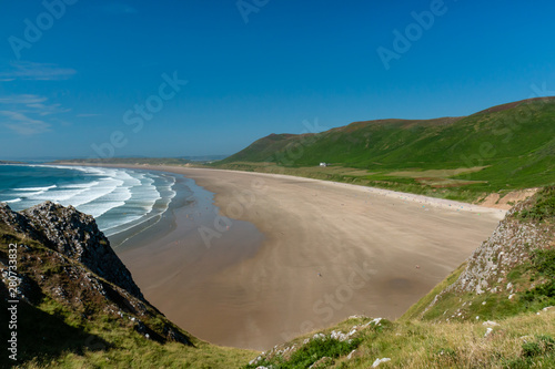 Surf and waves breaking on a huge  golden sandy beach