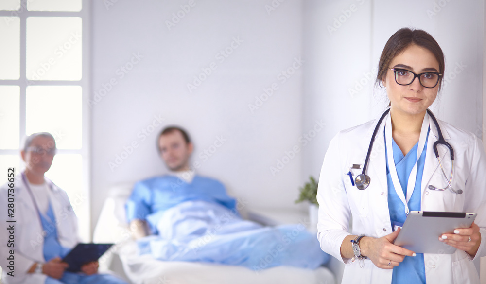 Doctor checking heart beat of patient in bed with stethoscope Doctor checking heart beat of patient in bed with stethoscope