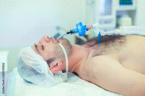Anesthesiologist performing tracheal intubation in operation room. Preparation for surgery.