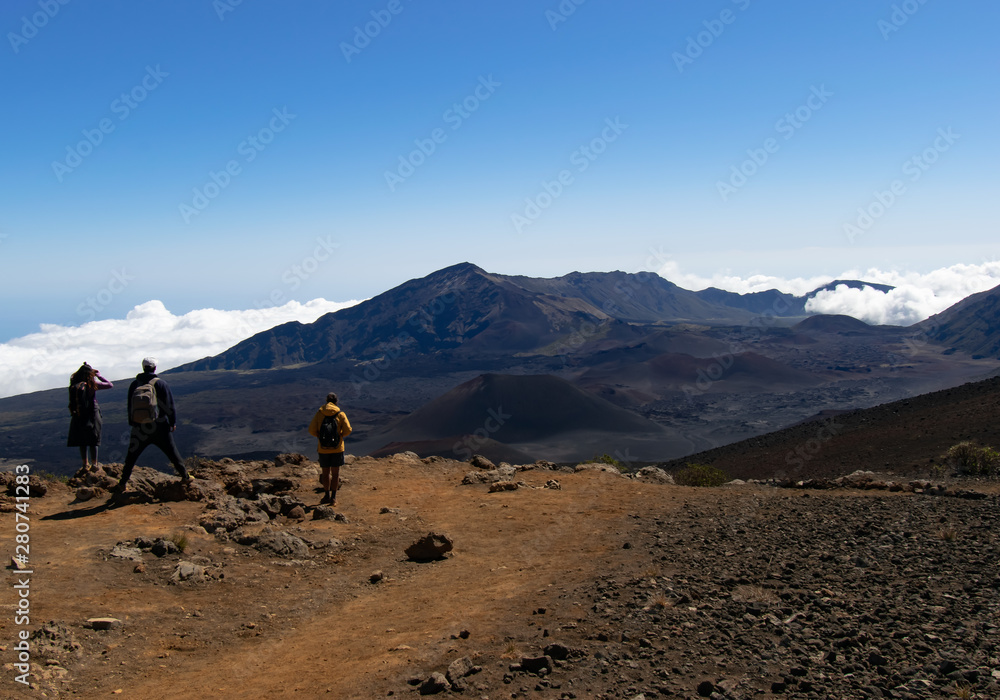 people observing the landscape of a crater and mountains
