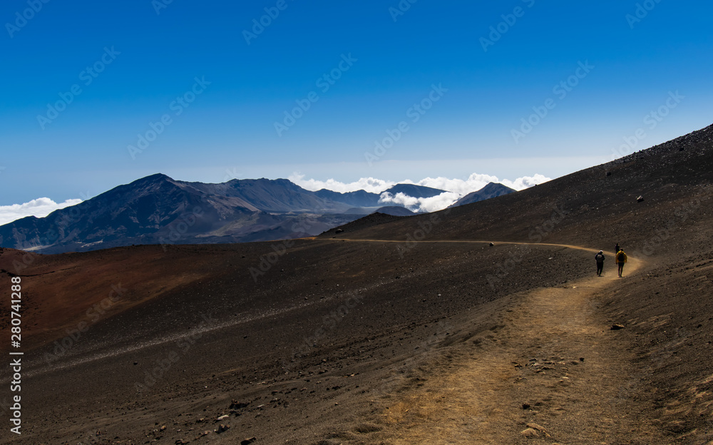 people walking on the crater of a volcano people walking on the crater of a volcano