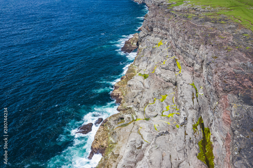 Aerial view of Koltur island in Faroe Islands, North Atlantic Ocean. Photo made by drone from above. Nordic Natural Landscape. Aerial view of Koltur island in Faroe Islands, North Atlantic Ocean. Photo made by drone from above. Nordic Natural Landscape.