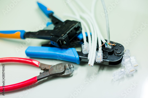 Crimper and wire cutter isolated on a white background. Twisting Cable Tool Twisted Pair Ethernet UTP Cat 5, Crimping RJ45 LAN cable, Stepping to crimping RJ45 connector.
