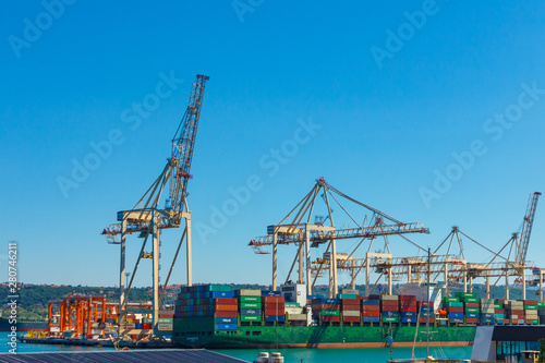 Cranes unloading a ship in a harbor. Koper  Slovenia - 27.07.2019