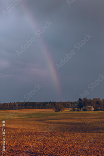 Almost invisible rainbow in the countryside