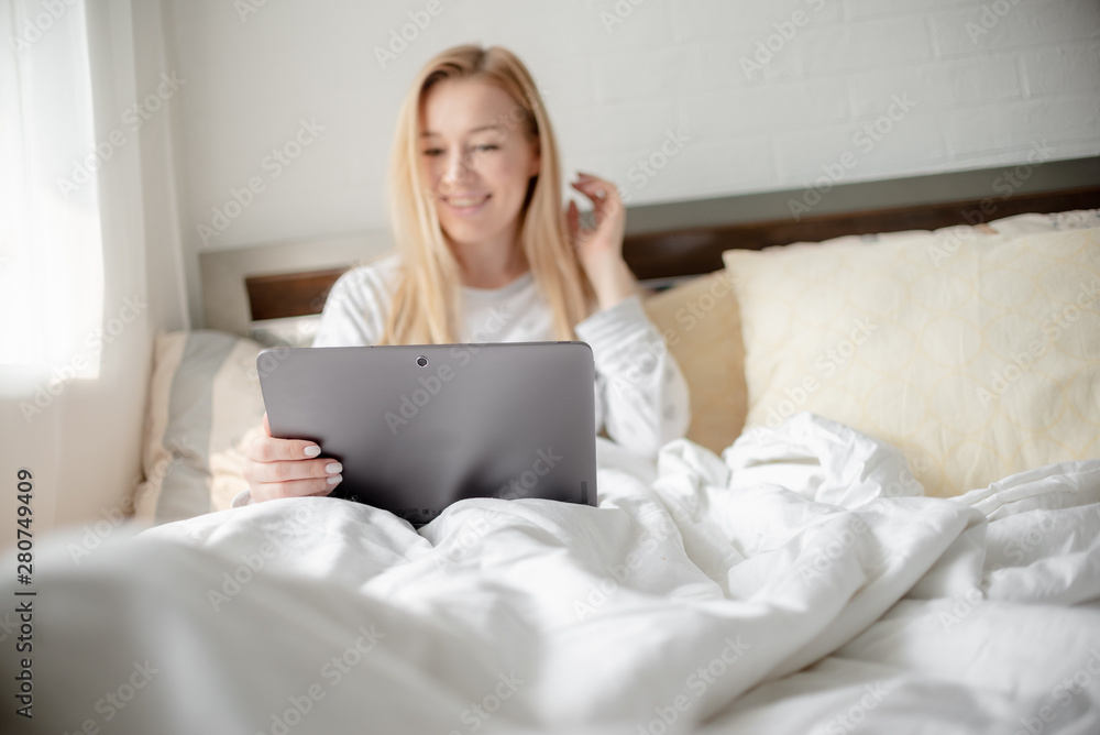 Work from home concept . Blonde Giirl typing and using laptop. Hygge Horizontal copyspace Work from home concept . Blonde Giirl typing and using laptop. Hygge Horizontal copyspace
