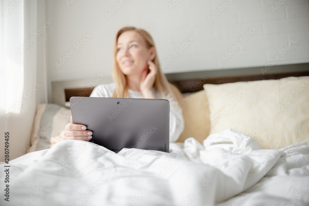 Work from home concept . Blonde Giirl typing and using laptop. Hygge Horizontal copyspace Work from home concept . Blonde Giirl typing and using laptop. Hygge Horizontal copyspace