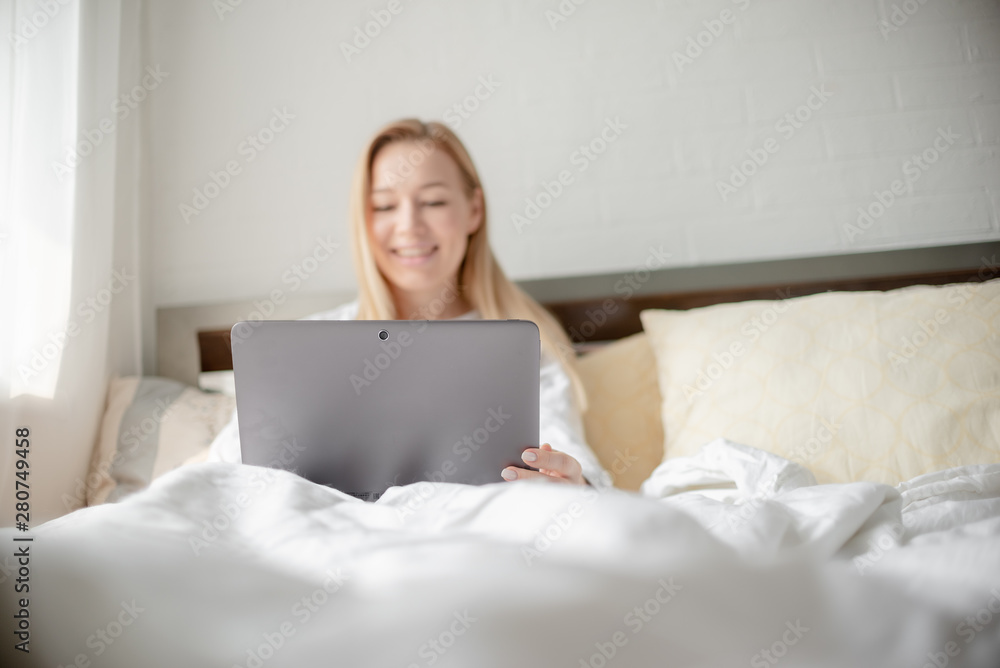 Work from home concept . Blonde Giirl typing and using laptop. Hygge Horizontal copyspace Work from home concept . Blonde Giirl typing and using laptop. Hygge Horizontal copyspace