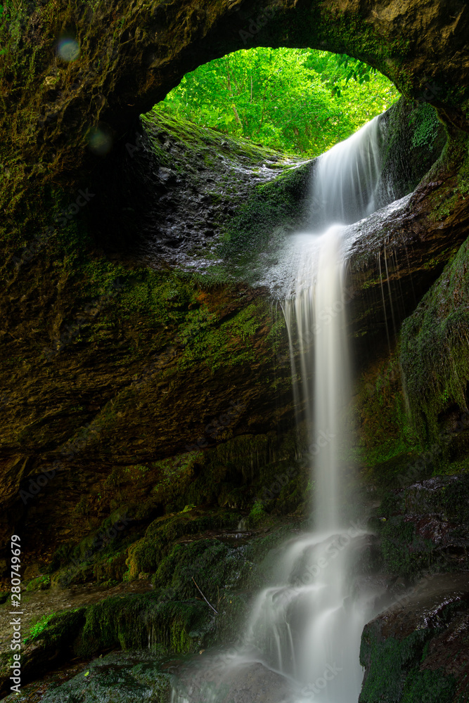 Fototapeta premium Long exposure Murgul Deliklikaya waterfall over brown and green rocks.