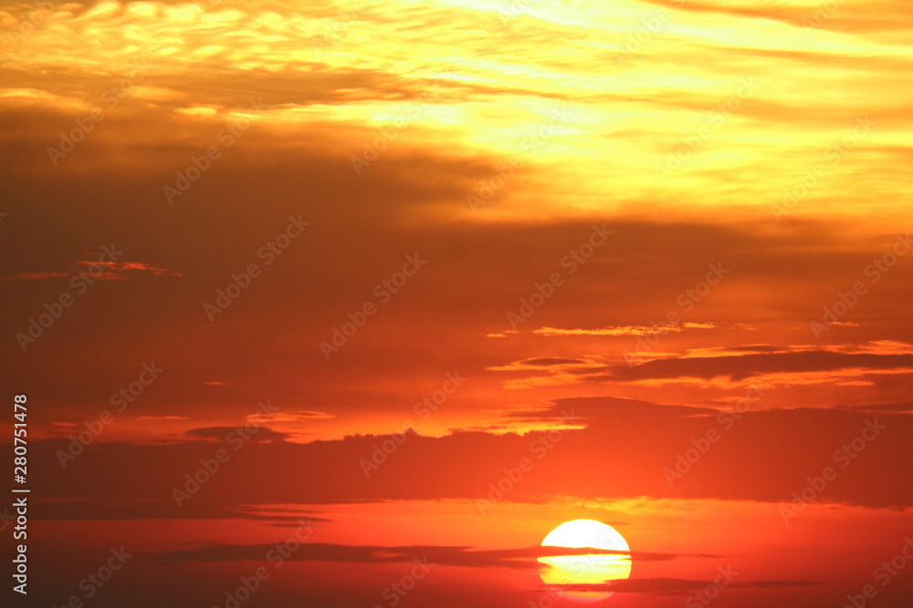 sunset on red orange sky back soft evening cloud over horizon sea