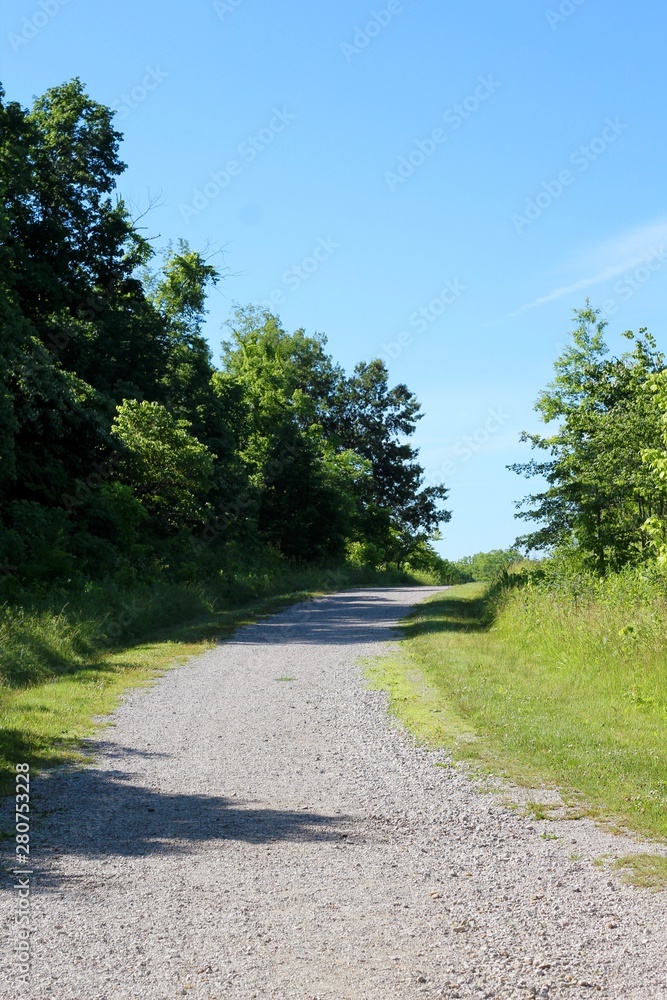 The long empty pathway up the hill on a sunny day.